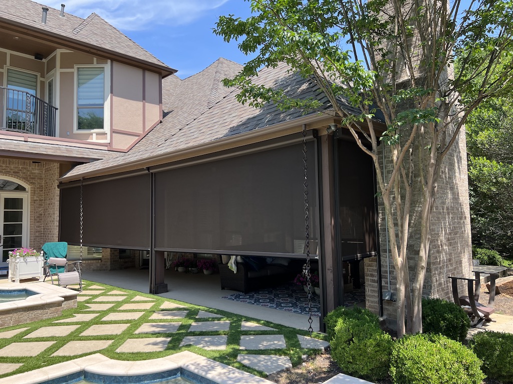 House patio area enclosed with custom-colored motorized retractable screens