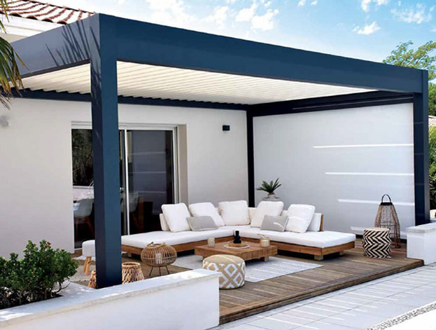 Modern outdoor patio with a sleek pergola, white cushioned sectional seating, wooden deck flooring, and decorative accents