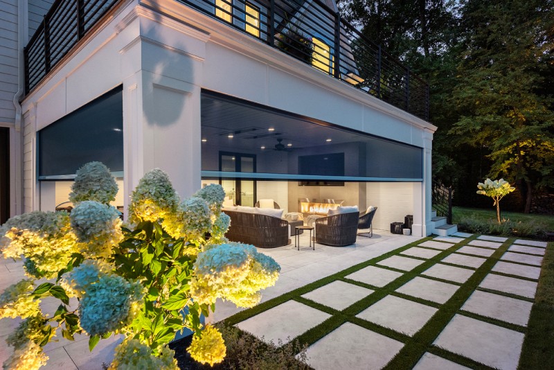 Retractable screens partially lowered around a covered patio